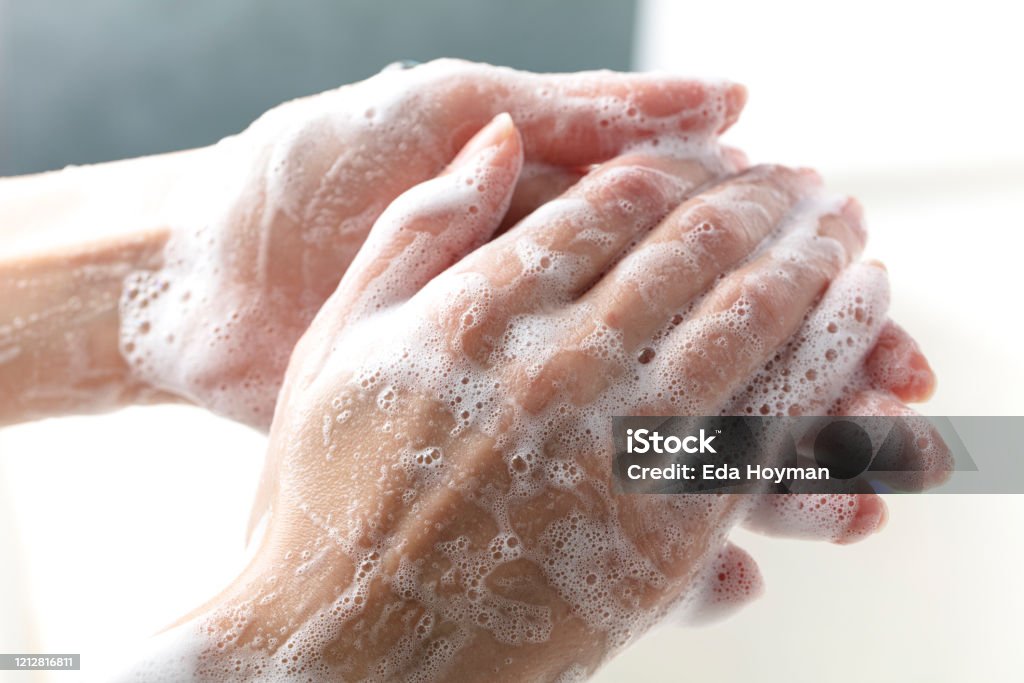 Hands being washed with soap